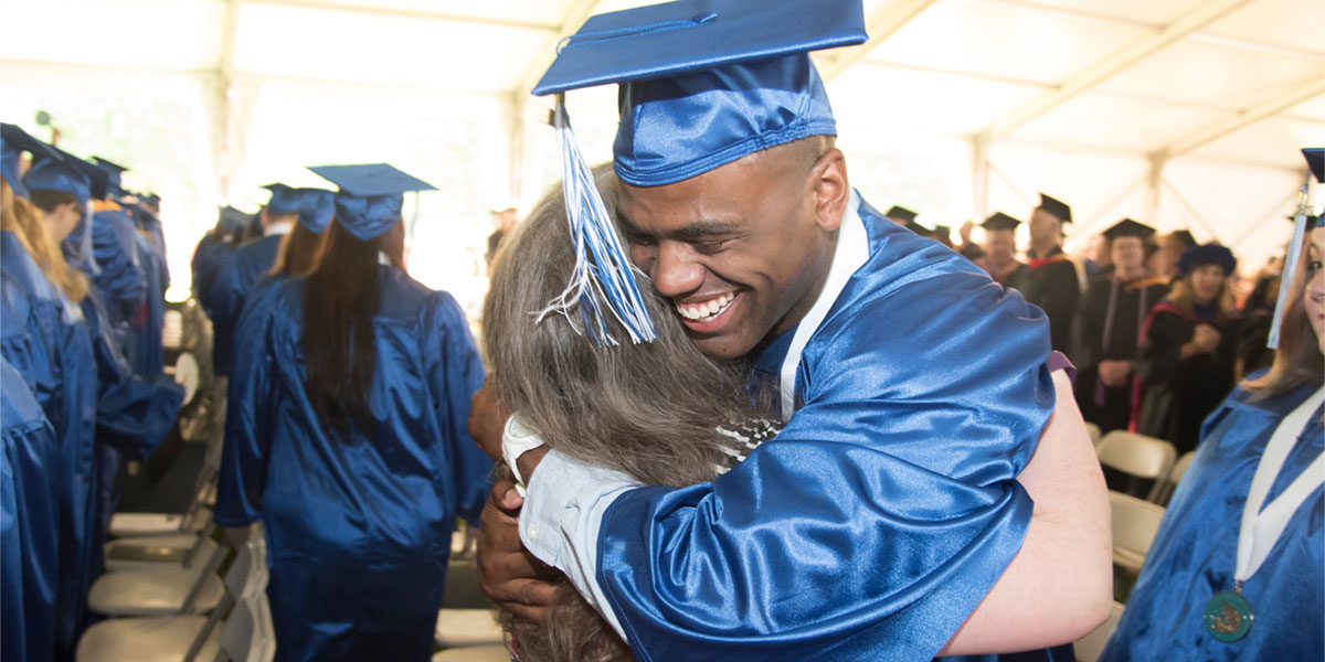 AACC graduate hugging his mom.