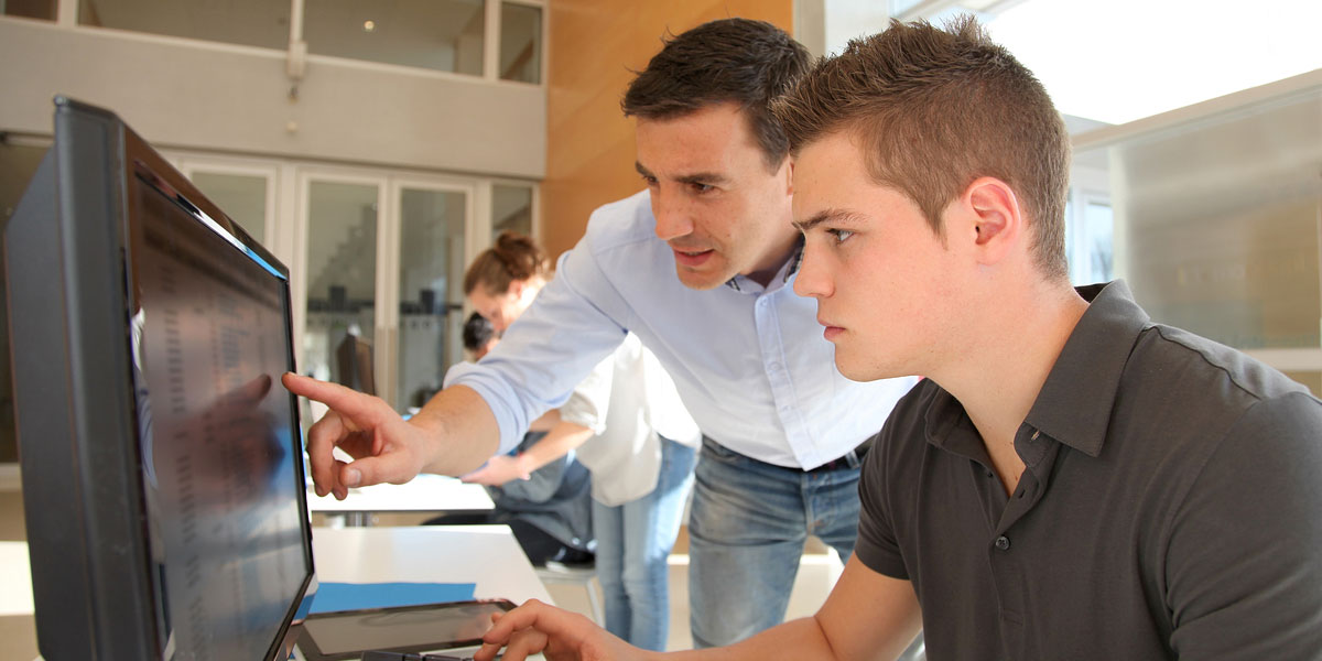 Instructor and student using a computer.