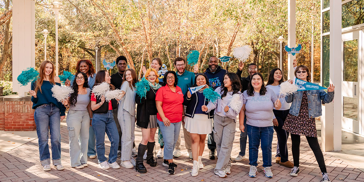 Students outside waving AACC promo items