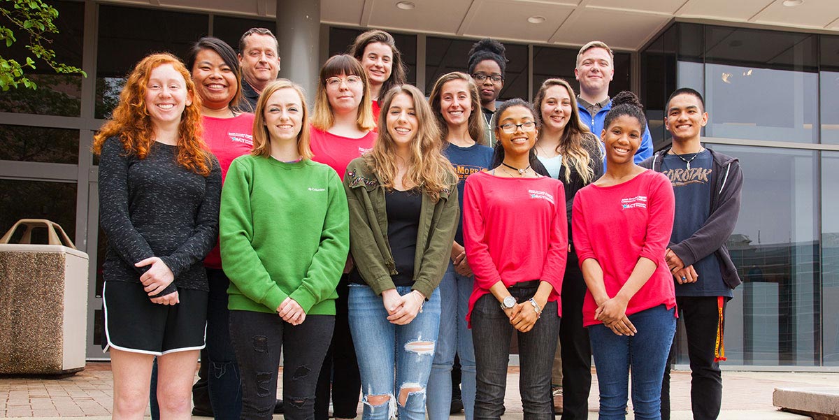 2018 Campus ambassadors pose in front of library.