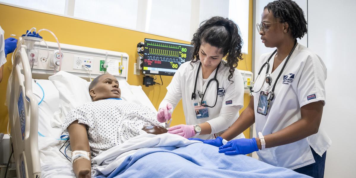 Nursing students with manikin.