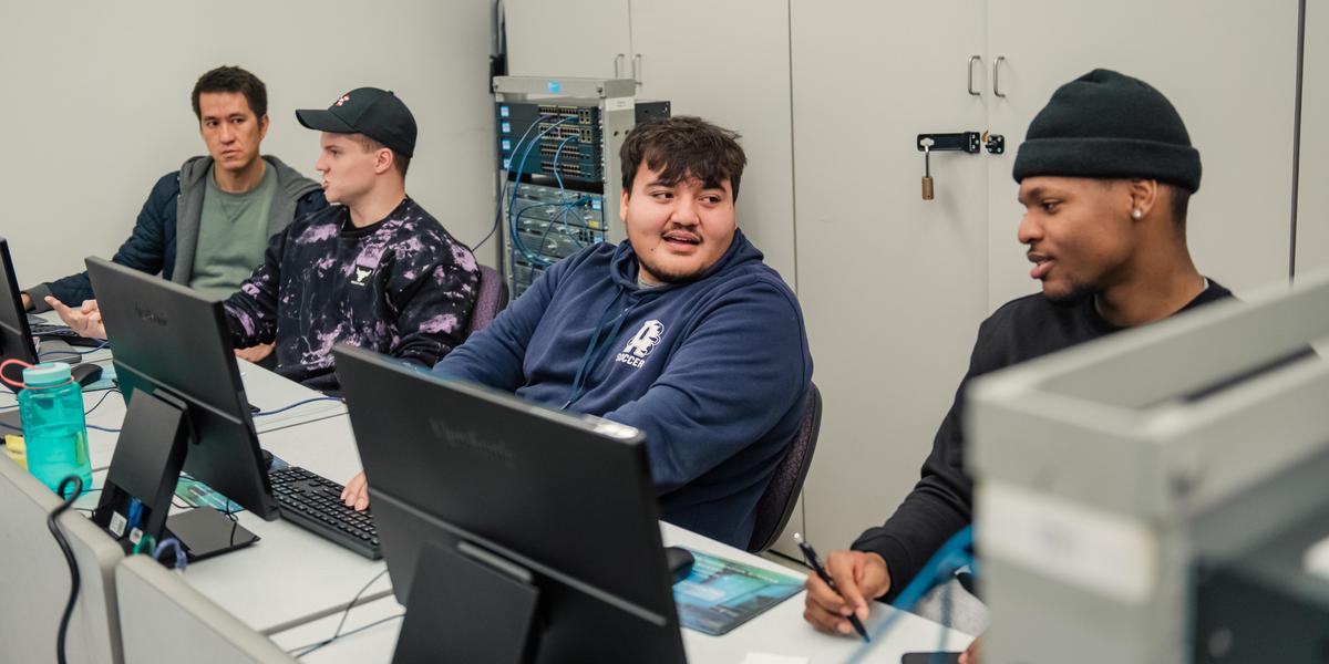 Row of students working on computers.